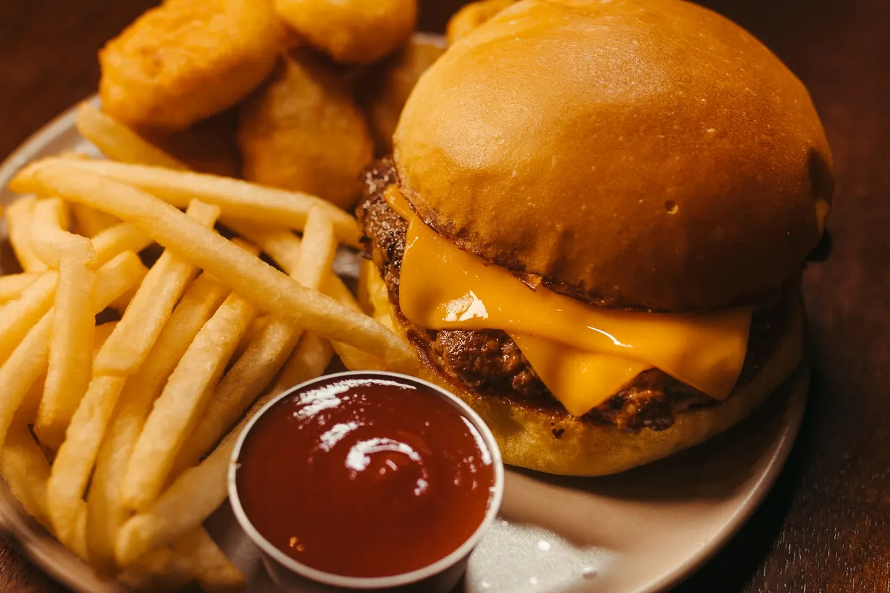 Cheeseburger with fries and ketchup.