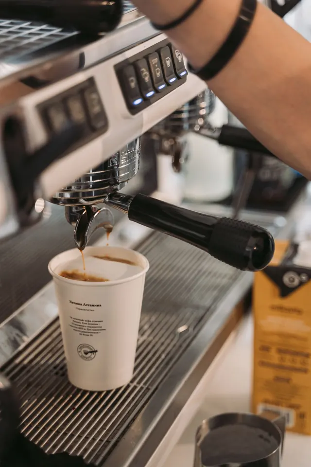 Espresso pouring into a cup at the machine.